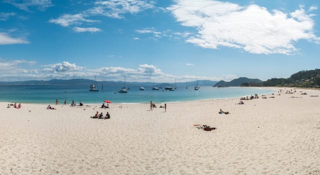 ISLAS CIES, SPAIN - CIRCA SEPTEMBER 2017: Unidentified people relax on the sand beach of Playa de Rodas on the Cies Islands of Spain, included in the Atlantic Islands of Galicia National Park.