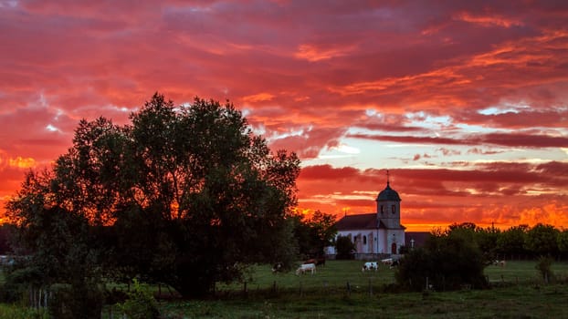 Amazing sunset and colourful sky in a village in France