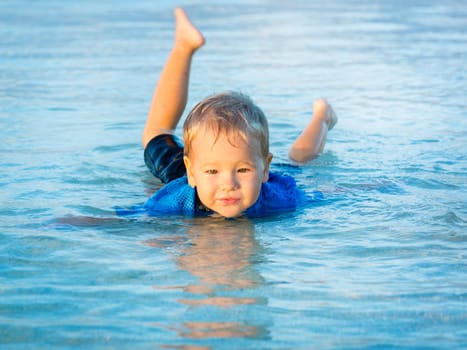 Cute boy plays in a sea
