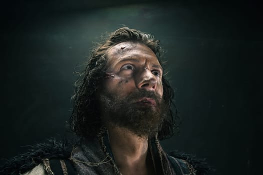Portrait of a brutal bald-headed viking in a battle mail posing against a black background. Early medieval period.