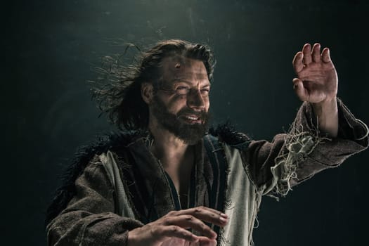 Portrait of a brutal bald-headed viking in a battle mail posing against a black background. Early medieval period.