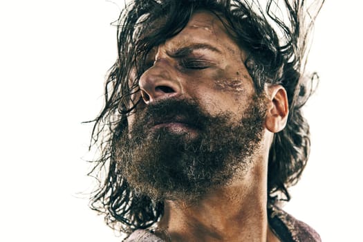 Portrait of a brutal bald-headed viking in a battle isolated against a white background. Early medieval period. Actor in makeup. concept of vagrancy and survival