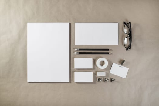 Photo of blank stationery set on craft paper background. Corporate ID template. Responsive design mockup. Top view.