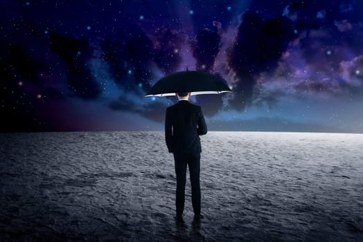 Back view of business man holding umbrella from outer space