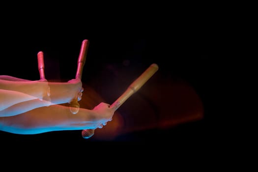 The male hands of table tennis player close up on black background. Stroboscope shooting technique