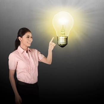 Asian business woman pointing lamp bulb. Business idea concept