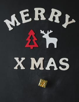 Old chalkboard with the words Merry xmas, Christmas card background