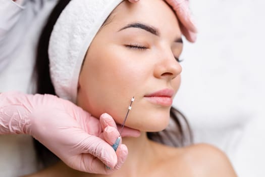Face lifting PDO Suture operation. innovative technique of New thread lift, cosmetologist preparing to do procedure to female client, select the appropriate thread option.