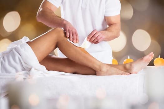 Therapist Waxing Woman's Leg With Wax Strip In Beauty Spa