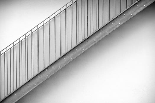 The detail of an external staircase made of stainless steel.