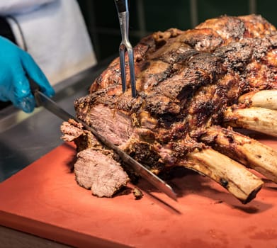 Chef Carving prime rib of  roast Wagyu beef