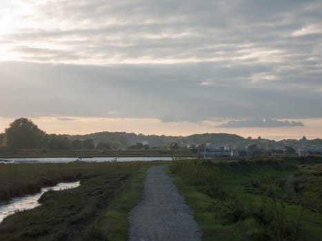 an empty country coastal walkway trail path outside low setting light  England  Essex