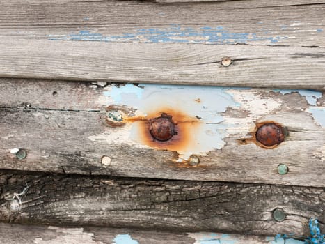 close up texture of decaying wooden boat with rusty nails