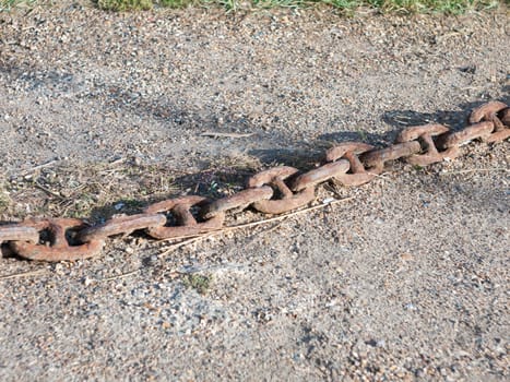 old rusty metal chain across the stone floor outside  England  Essex