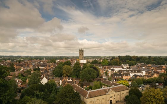 Warwick, United Kingdom - September 19, 2016: View of the Medieval castle tower and gatehouse from within the castle gardens and people enjoying the setting, Warwick, Warwickshire