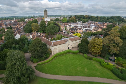 Warwick, United Kingdom - September 19, 2016: View of the Medieval castle tower and gatehouse from within the castle gardens and people enjoying the setting, Warwick, Warwickshire