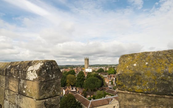 Warwick, United Kingdom - September 19, 2016: View of the Medieval castle tower and gatehouse from within the castle gardens and people enjoying the setting, Warwick, Warwickshire