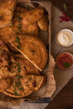 Different pies from meat and vegetables. Freshly baked cakes on a table