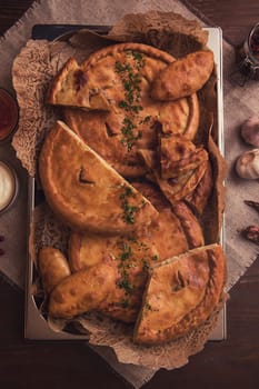 Different pies from meat and vegetables. Freshly baked cakes on a table