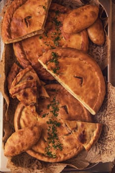 Different pies from meat and vegetables. Freshly baked cakes on a table