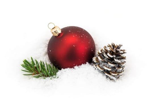 Christmas ball in the snow,Christmas decoration with pine cones and fir branch