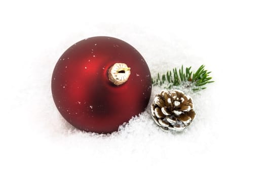 Christmas ball in the snow,Christmas decoration with pine cones and fir branch