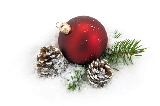Christmas ball in the snow,Christmas decoration with pine cones and fir branch
