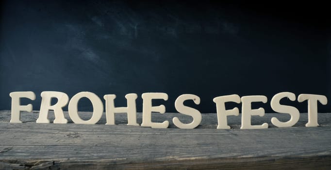 Old chalkboard with the German words Merry Christmas, holiday concept background