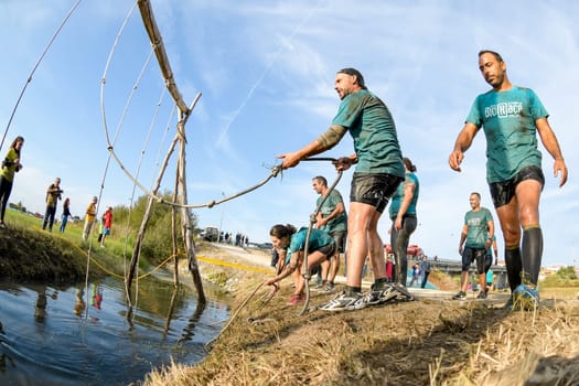 ESTARREJA, PORTUGAL - SEPTEMBER 23: Athletes go through mud and water at the Biorace on september 23, 2017 in Estarreja, Portugal.