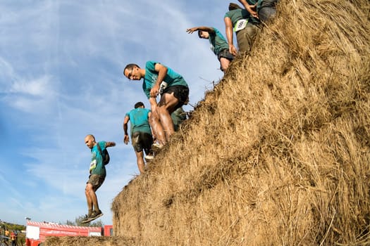 ESTARREJA, PORTUGAL - SEPTEMBER 23: Athletes overcoming the hay osbtacle at the Biorace on september 23, 2017 in Estarreja, Portugal.