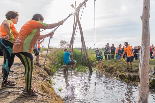ESTARREJA, PORTUGAL - SEPTEMBER 23: Athletes go through mud and water at the Biorace on september 23, 2017 in Estarreja, Portugal.