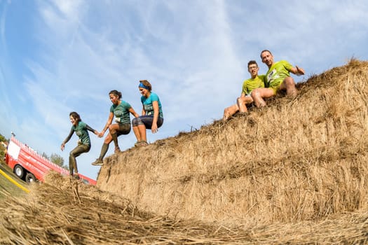 ESTARREJA, PORTUGAL - SEPTEMBER 23: Athletes overcoming the hay osbtacle at the Biorace on september 23, 2017 in Estarreja, Portugal.
