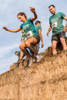 ESTARREJA, PORTUGAL - SEPTEMBER 23: Athletes overcoming the hay osbtacle at the Biorace on september 23, 2017 in Estarreja, Portugal.
