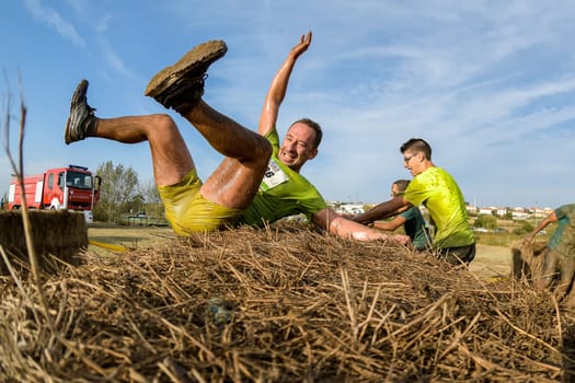 ESTARREJA, PORTUGAL - SEPTEMBER 23: Athletes overcoming the hay osbtacle at the Biorace on september 23, 2017 in Estarreja, Portugal.