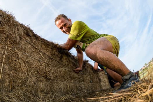 ESTARREJA, PORTUGAL - SEPTEMBER 23: Athletes overcoming the hay osbtacle at the Biorace on september 23, 2017 in Estarreja, Portugal.