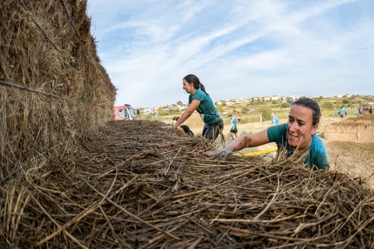 ESTARREJA, PORTUGAL - SEPTEMBER 23: Athletes overcoming the hay osbtacle at the Biorace on september 23, 2017 in Estarreja, Portugal.