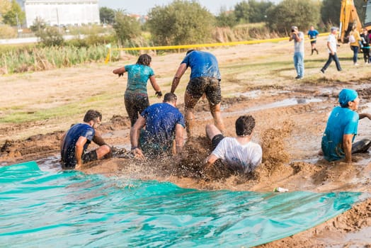 ESTARREJA, PORTUGAL - SEPTEMBER 23: Athletes sliding to mud and water at the Biorace on september 23, 2017 in Estarreja, Portugal.