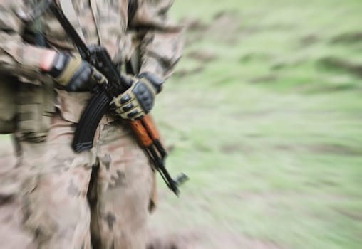 close up on soldier with machine gun,motion blur