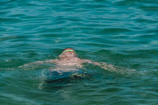 close up on swimming child in the water