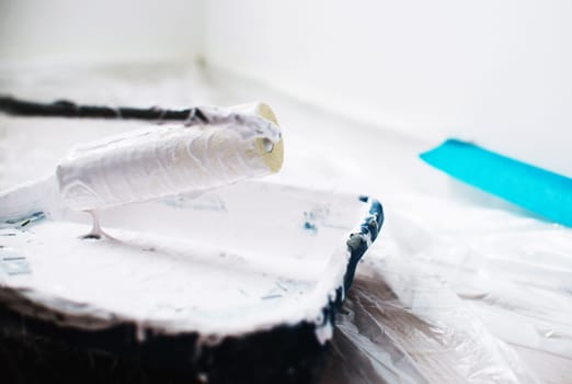 close up on brush with white pain,home repair,wall painting