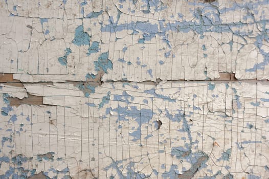 Texture, pattern, background. old paint. the wooden wall cracked with paint. With a white tinge, the paint eventually peels off