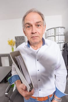 elderly man with a white shirt hands over a file folder