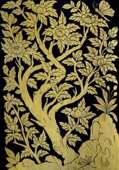Ancient Thai gold leaf art on temple window in Bangkok, Thailand
