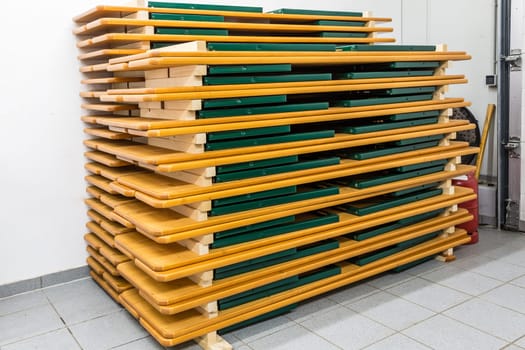 Several beer tent sets stacked on top of each other in storage space.