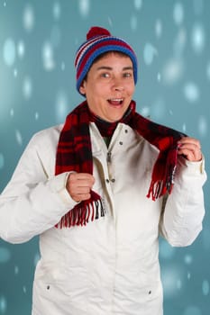 Middle-aged woman in winter clothes on a blue background