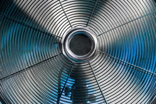 Vintage spinning ventilator with a cold blue background
