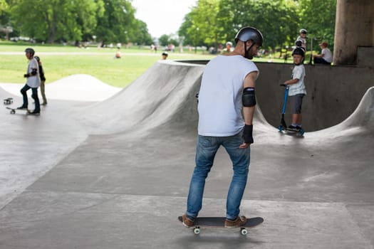 Stockholm, Sweden - July 11, 2017 : Powerful funny young guys are trained in a skate park. Leisure, playing, trick