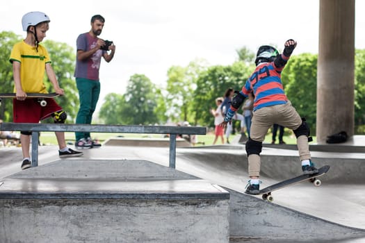 Stockholm, Sweden - July 11, 2017 : Powerful funny young guys are trained in a skate park. Leisure, playing, trick