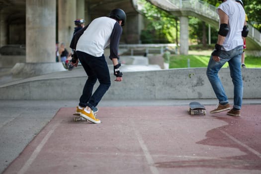 Powerful funny young guys are trained in a skate park Stockholm, Sweden. Leisure, playing, trick