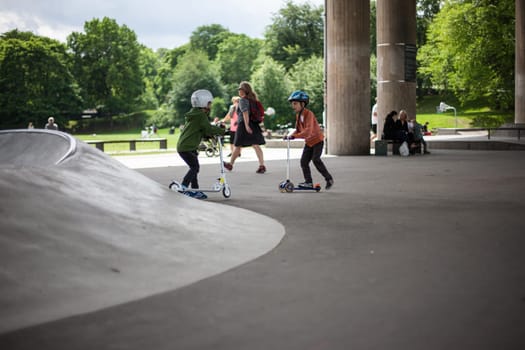 Stockholm, Sweden - July 11, 2017 : Powerful funny young guys are trained in a skate park. Leisure, playing, trick